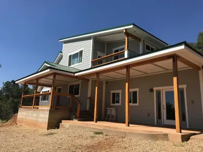 a house with a wrap around porch with a balcony at Morning Star Vista near Yosemite - countryside with mountain views in Mariposa