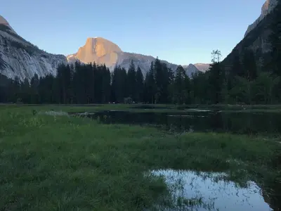 a mountain reflection in a lake in a field at Morning Star Vista near Yosemite - countryside with mountain views in Mariposa