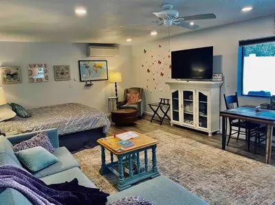 a living room with a bed and a tv at Butterfly Suite Hot Tub BBQ Private in Ahwahnee