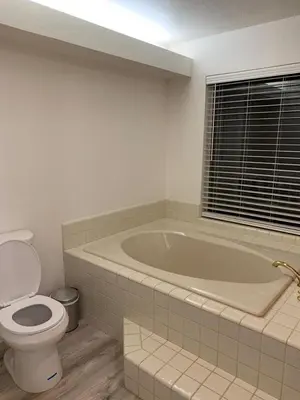 a bathroom with a bath tub and a toilet at Executive home in a serene park like setting in Folsom