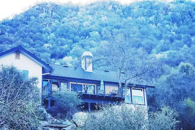 a house on a hill in the middle of a mountain at **Kaweah River House** - 1/2 Mile to Sequoia Park in Three Rivers