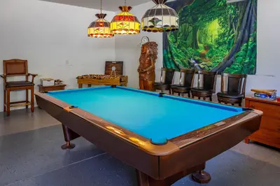 a pool table in a room with chairs and a painting at Sierra River House 5 min to Sequoia Park Entrance in Three Rivers