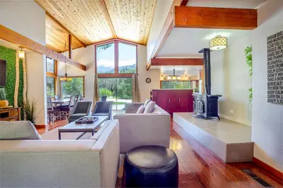 a living room with couches and a fireplace at Sequoia River House, close to SNP, 2 Decks on Amazing River on 7acres in Three Rivers