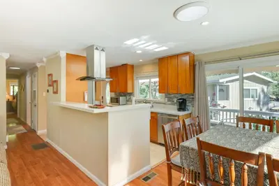 a kitchen and dining room with a table and chairs at Groveland Vacation Rental with Private Deck and Grill! in Groveland