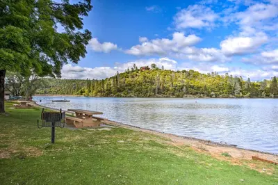 a park with a picnic table and a lake at Groveland Vacation Rental with Private Deck and Grill! in Groveland