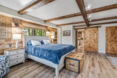 a bedroom with a bed and a wooden ceiling at Water's Edge - Gorgeous Water Views! home in Groveland
