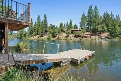 a dock with a boat on a lake at Water's Edge - Gorgeous Water Views! home in Groveland