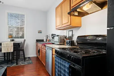 a kitchen with a black stove and a table at Cozy 1 bdr/1br near downtown in Sacramento