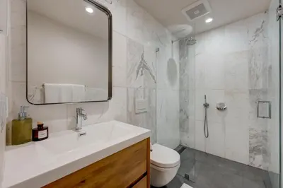 a bathroom with a sink and a toilet and a mirror at Luxury Tahoe Getaway in Incline Village in Incline Village