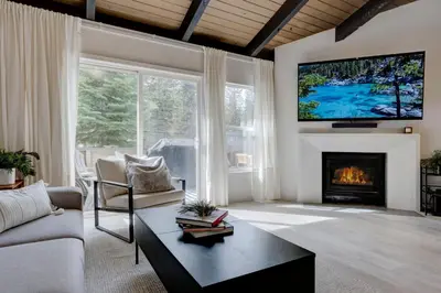 a living room with a fireplace and a tv on the wall at Luxury Tahoe Getaway in Incline Village in Incline Village
