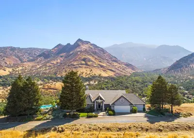 a house with mountains in the background at Number 1! PARADISE Getaway - Sequoia Alta Vista in Three Rivers