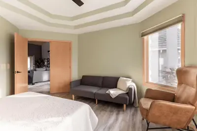 a bedroom with a bed and a couch and a window at Number 1! PARADISE Getaway - Sequoia Alta Vista in Three Rivers