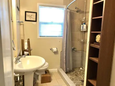 a bathroom with a sink and a toilet and a shower at Smart Eclectic ART HOUSE near the beat in Sacramento