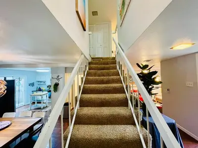 a staircase in a living room with a stair case at Artists Condo GAME ROOM Patio near UC Med Center in Sacramento