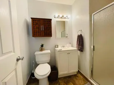 a bathroom with a toilet and a sink and a shower at Artists Condo GAME ROOM Patio near UC Med Center in Sacramento