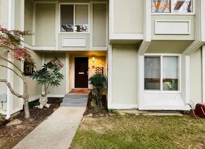 a white house with a door and a porch at Artists Condo GAME ROOM Patio near UC Med Center in Sacramento