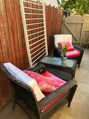 two wicker chairs and a table on a patio at Smart Eclectic ART HOUSE near UC Davis Med Center in Sacramento