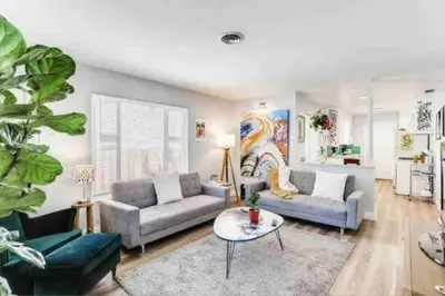 a living room with two couches and a table at Smart Eclectic ART HOUSE near UC Davis Med Center in Sacramento