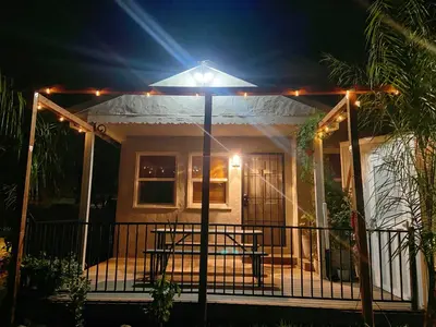 a house with a light on the front porch at night at Sweet Home with Ample Parking Only 2mins to Freeway in Sacramento