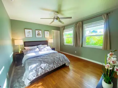 a bedroom with a bed and two windows at Sweet Home in Sacramento Only 2mins to Freeway in Sacramento