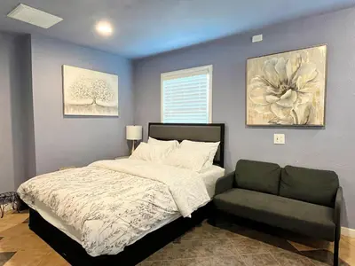 a bedroom with a bed and a chair at Sweet Home in Sacramento Only 2mins to Freeway in Sacramento