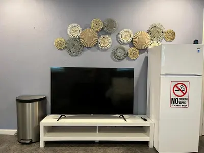 a flat screen tv sitting on top of a white entertainment center at Sweet Home in Sacramento Only 2mins to Freeway in Sacramento