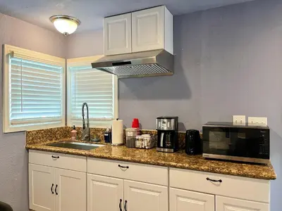 a kitchen with a counter with a microwave and a sink at Sweet Home in Sacramento Only 2mins to Freeway in Sacramento