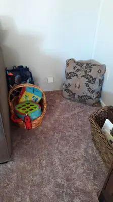 a room with a basket of toys and a pillow at Fairway Apartments Unit 1 in Twain Harte