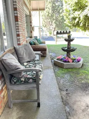 a chair sitting on a porch next to a fountain at Fairway Apartments Unit 1 in Twain Harte