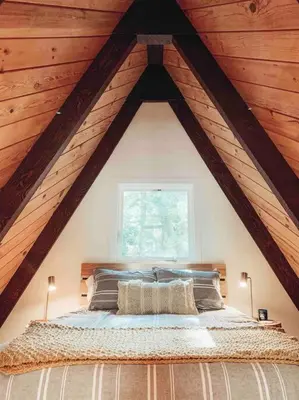 a bedroom with a large bed in a attic at Mid Century Modern Cabin - The Tahoe A-Frame in Homewood