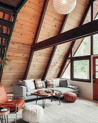 a living room with a couch and a table at Mid Century Modern Cabin - The Tahoe A-Frame in Homewood