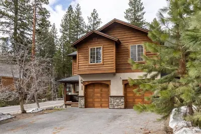 a wooden house with a garage at Bright 3BD Kings Beach Townhome in Kings Beach