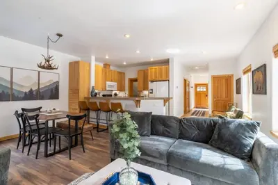 a living room and kitchen with a couch and a table at Bright 3BD Kings Beach Townhome in Kings Beach