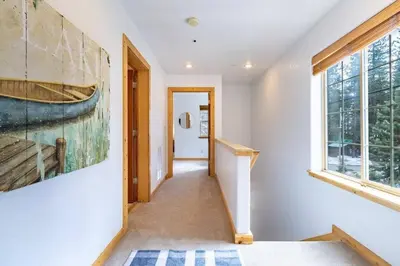 a hallway with a painting of a boat on the wall at Bright 3BD Kings Beach Townhome in Kings Beach