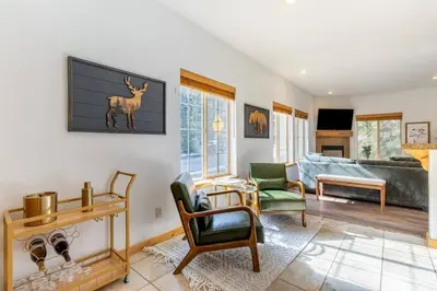 a living room with a couch and a deer on the wall at Bright 3BD Kings Beach Townhome in Kings Beach