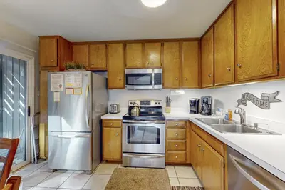 a kitchen with stainless steel appliances and wooden cabinets at Sierra Park Villas 39 H in Mammoth Lakes