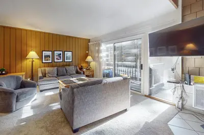 a living room with a couch and a tv at Sierra Park Villas 39 H in Mammoth Lakes