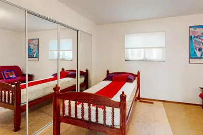 a bedroom with two beds and a mirror at Zen Amongst the Trees in Truckee