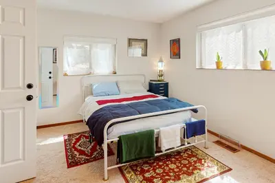 a bedroom with a bed and a rug at Zen Amongst the Trees in Truckee