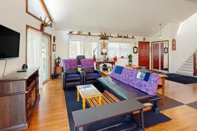 a living room with a couch and a tv at Zen Amongst the Trees in Truckee