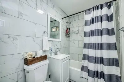a bathroom with a toilet and a sink and a shower at Fun City Haven Spacious Retreat in Fresno in Fresno