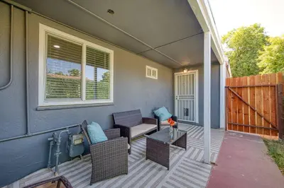 a patio with chairs and a table on a house at Fun City Haven Spacious Retreat in Fresno in Fresno