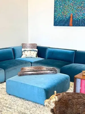 a blue couch with a large ottoman in a living room at Gondola Chalet -New Luxury 5 Bdrm Condo @ Canyon Lodge, Steam Room in Mammoth Lakes
