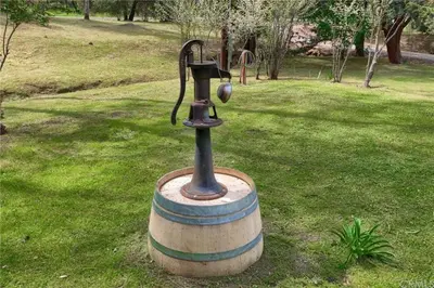 a water fountain in the middle of a park at Brookside Cottage in Mariposa