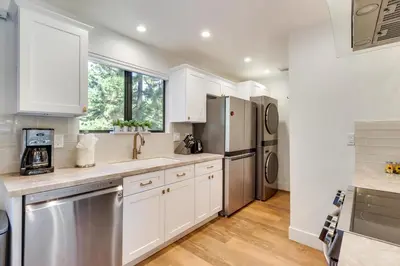 a kitchen with white cabinets and stainless steel appliances at Stylish Incline Village Vacation Rental with AandC! in Incline Village