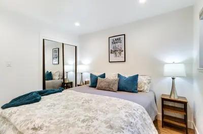 a bedroom with a large bed with blue pillows at Stylish Incline Village Vacation Rental with AandC! in Incline Village