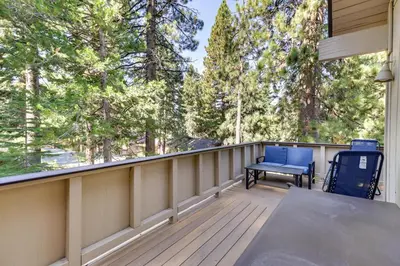 a deck with a table and chairs and trees at Stylish Incline Village Vacation Rental with AandC! in Incline Village