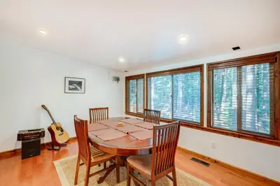 a dining room with a table and chairs and a guitar at Hike, Boat and Ski South Lake Tahoe Home in South Lake Tahoe