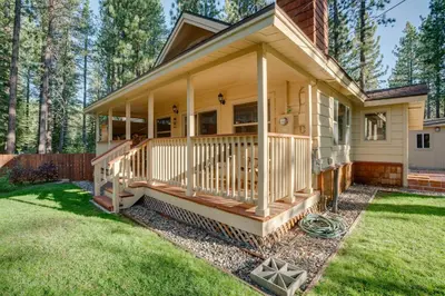 a house with a large deck on the front of it at Hike, Boat and Ski South Lake Tahoe Home in South Lake Tahoe