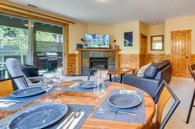 a dining room with a table and a fireplace at Boulders Truckee Condo Near Donner Lake and Skiing! in Truckee